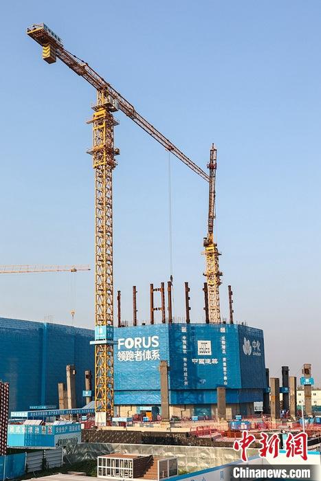 從完成頂層設(shè)計(jì)到如火如荼大規(guī)模建設(shè)，六年來(lái)，雄安新區(qū)如春天的竹子一般拔節(jié)生長(zhǎng)，這座承載千年大計(jì)的“未來(lái)之城”已雄姿初顯。從“一張白紙”開(kāi)始著墨，如今的雄安新區(qū)已是濃墨重彩的“山水畫(huà)”。<a target='_blank' href='/'>中新社</a>記者近日走訪(fǎng)了雄安新區(qū)多地，從“藍(lán)綠金”三色感受這座“未來(lái)之城”的巨大變化。圖為7月19日，河北雄安新區(qū)，中國(guó)中化總部基地項(xiàng)目施工現(xiàn)場(chǎng)。 <a target='_blank' href='/'>中新社</a>記者 易海菲 攝